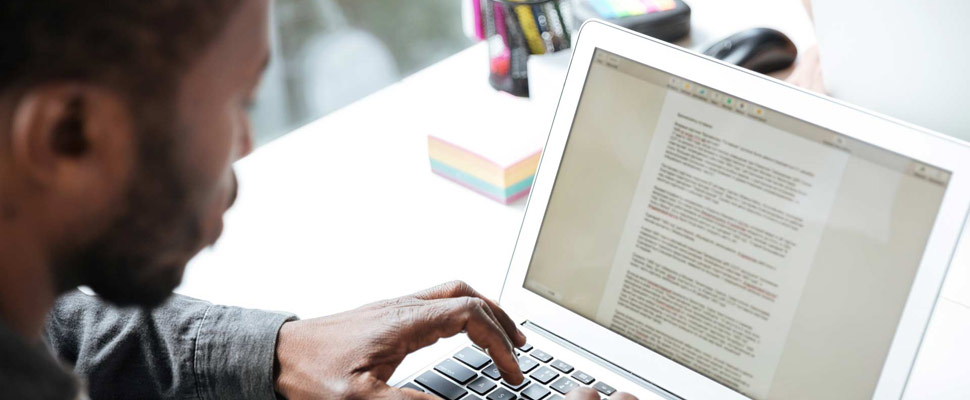 Cropped photo of serious young man sitting in office coworking