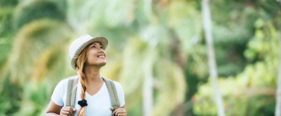 Young tourist woman with backpack enjoy nature looking away. Wom