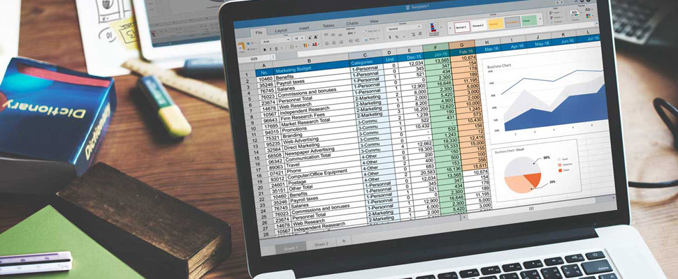 Closeup of hands using computer laptop with screen showing analy