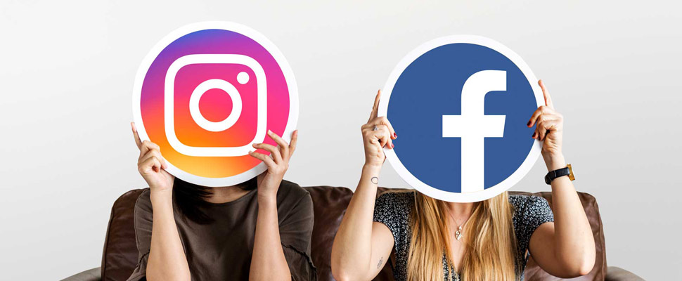 Interracial women holding an expressive emoticon face surprised