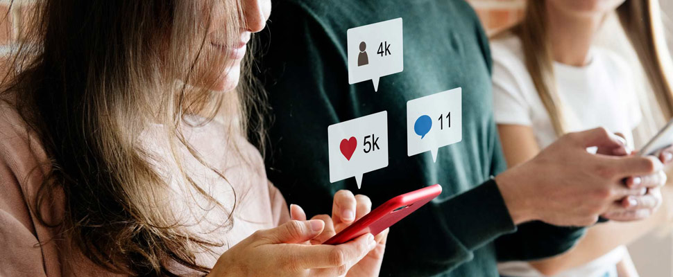 Happy friends using smartphones social media concept