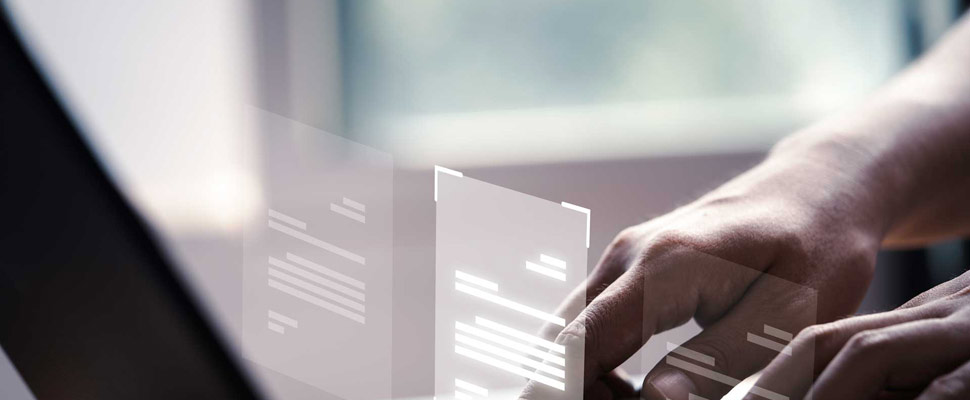 Hand using laptop computer with virtual screen and document for